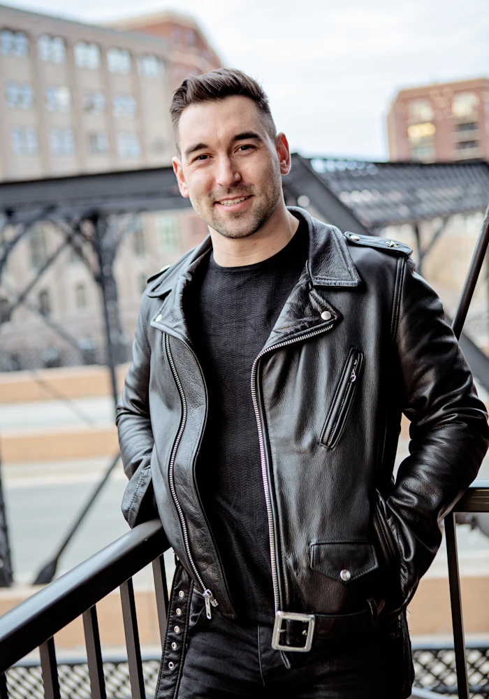 Man in a black leather biker jacket